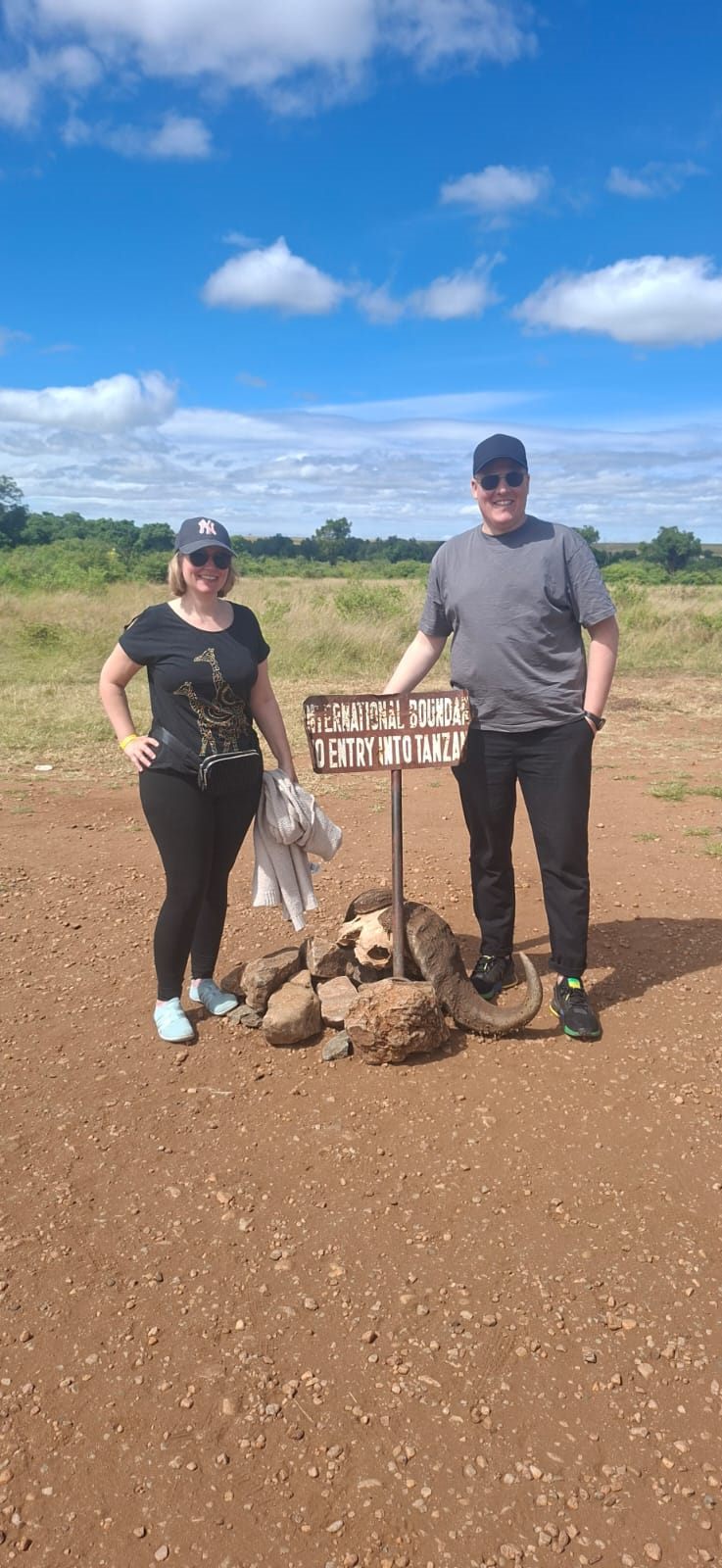 Almond Safaris travellers at the Kenya–Tanzania international boundary in the Maasai Mara